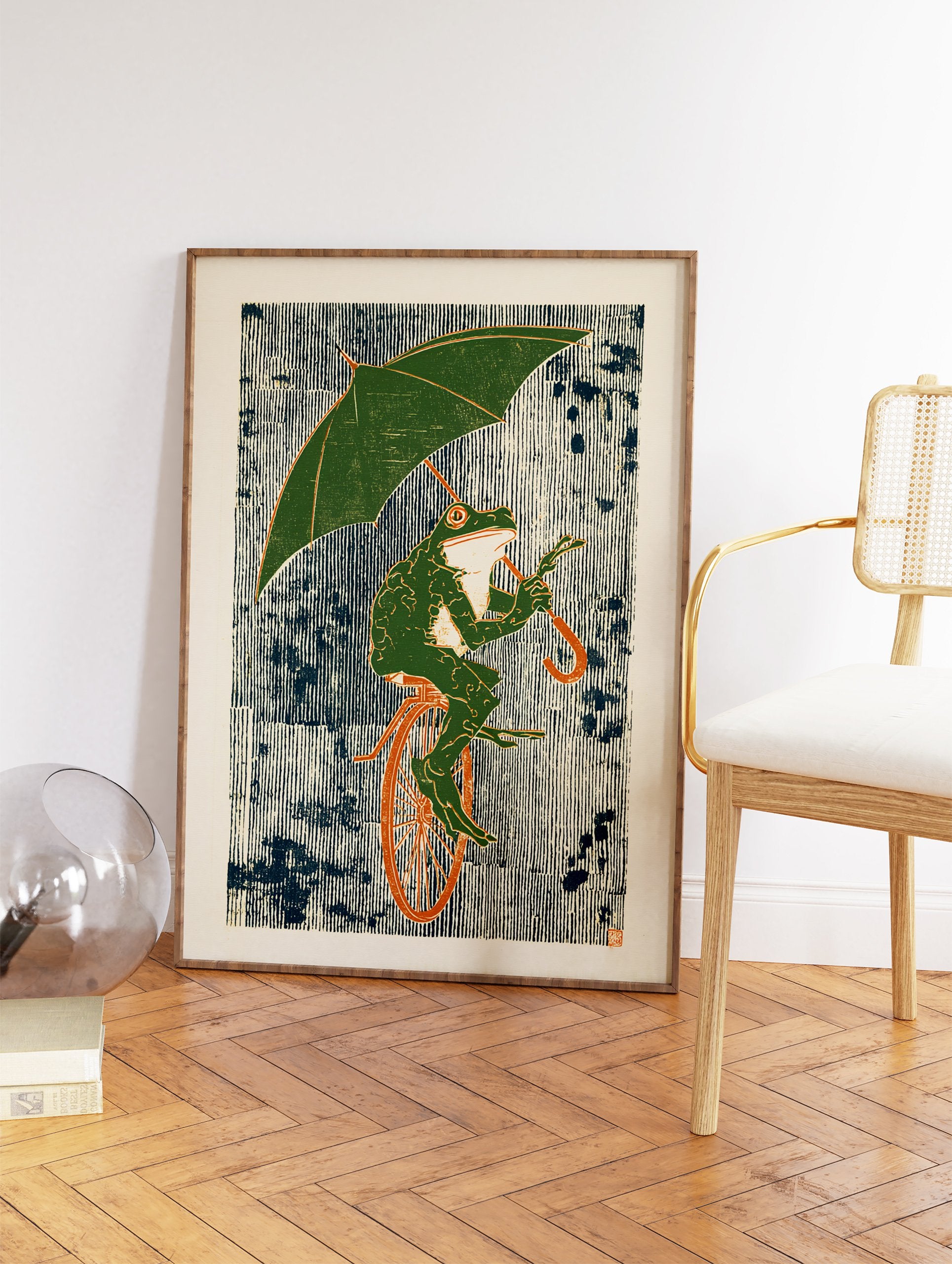 Whimsical green frog wall art print riding a unicycle and holding an umbrella against a striped blue and white background. - Image 2