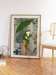 Whimsical green frog wall art print riding a unicycle and holding an umbrella against a striped blue and white background. - Image 2