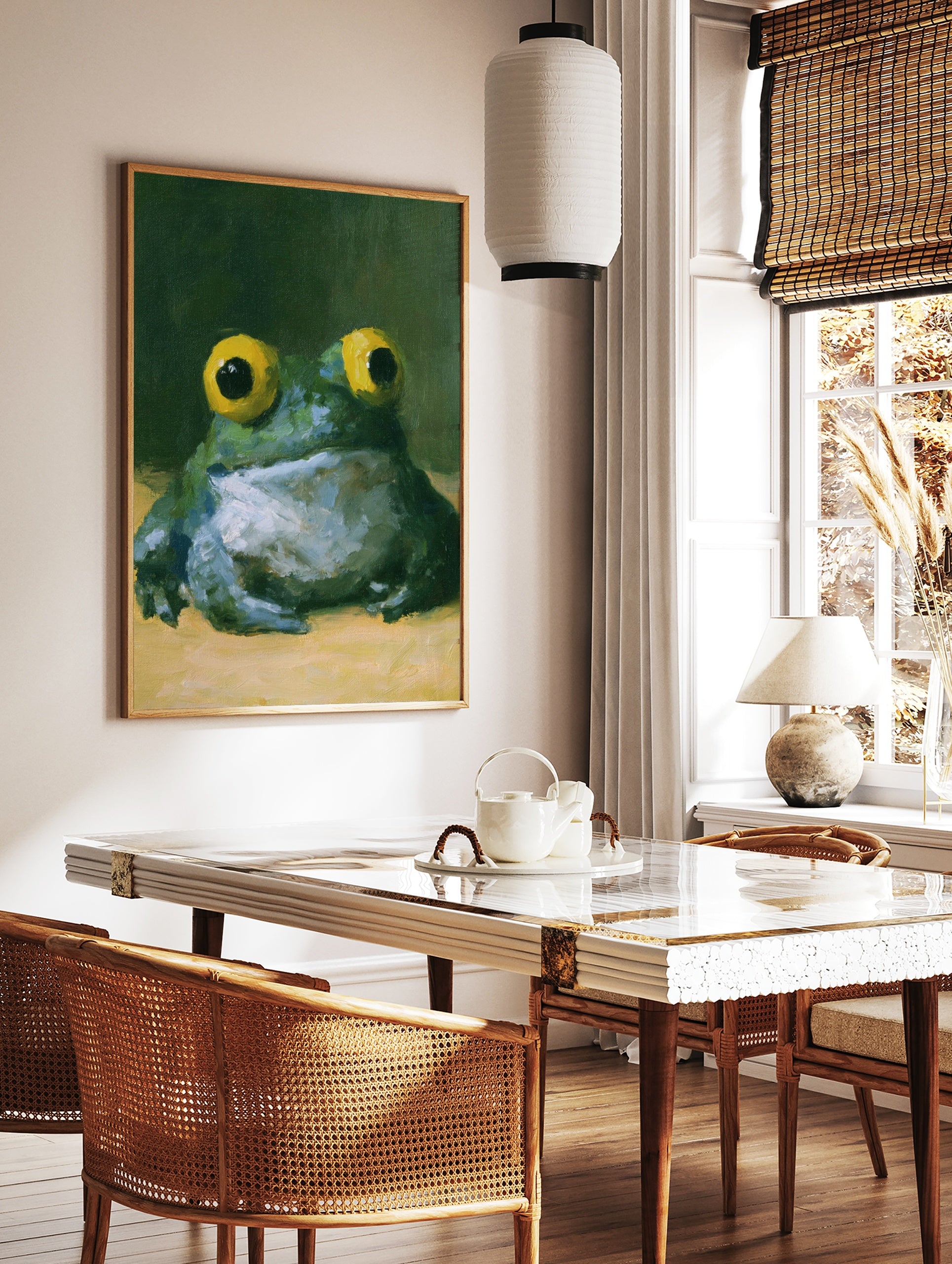 Painterly frog wall art with large yellow eyes and green textured skin against a dark background, in a styled room mockup