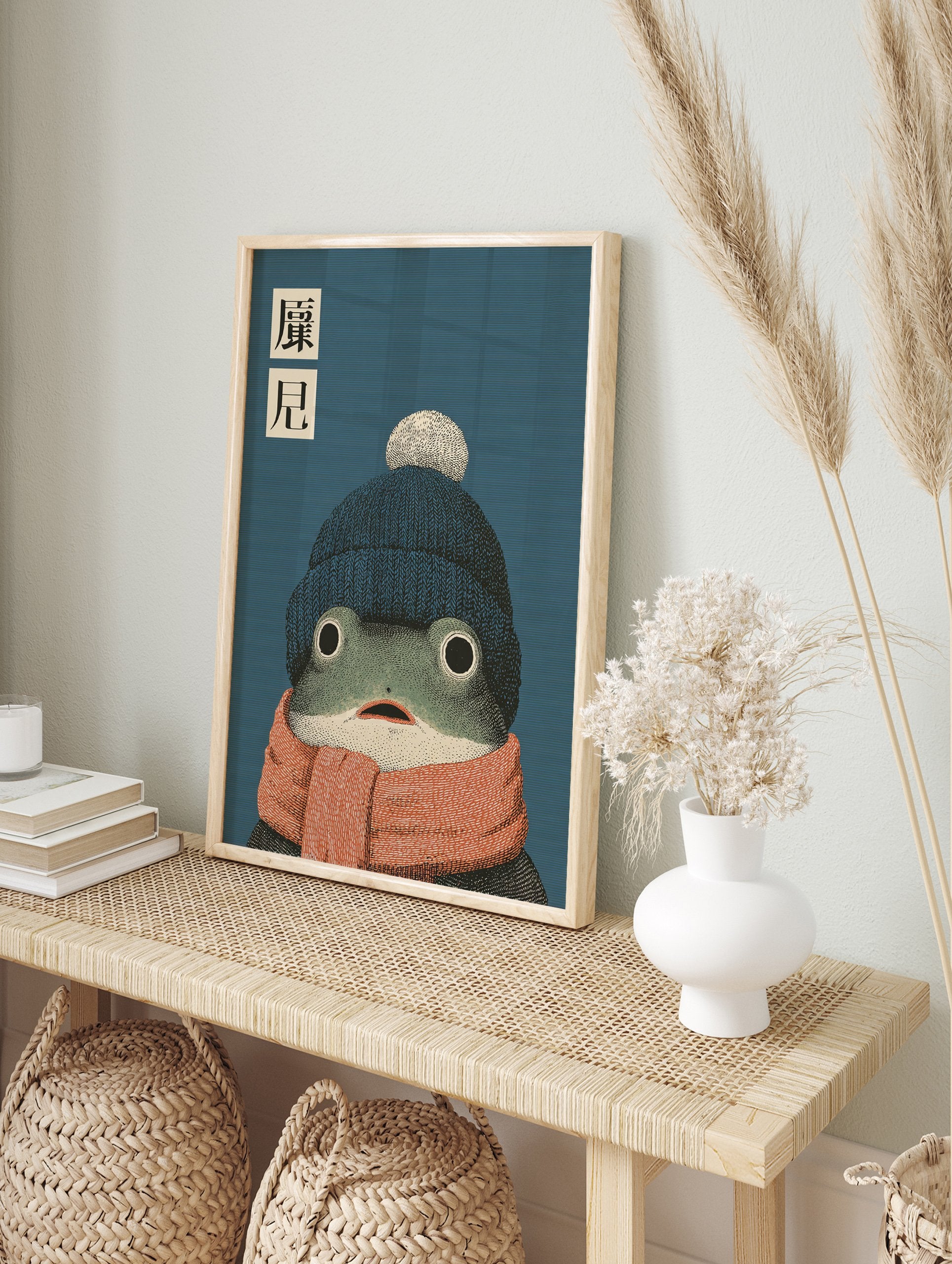 Whimsical frog wall art illustration wearing a blue beanie and orange scarf with Japanese text on a blue background. - Image 3