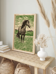 Illustrative woodcut-style print of a dark horse standing in a green field with a textured sky, in an alternate framed mockup