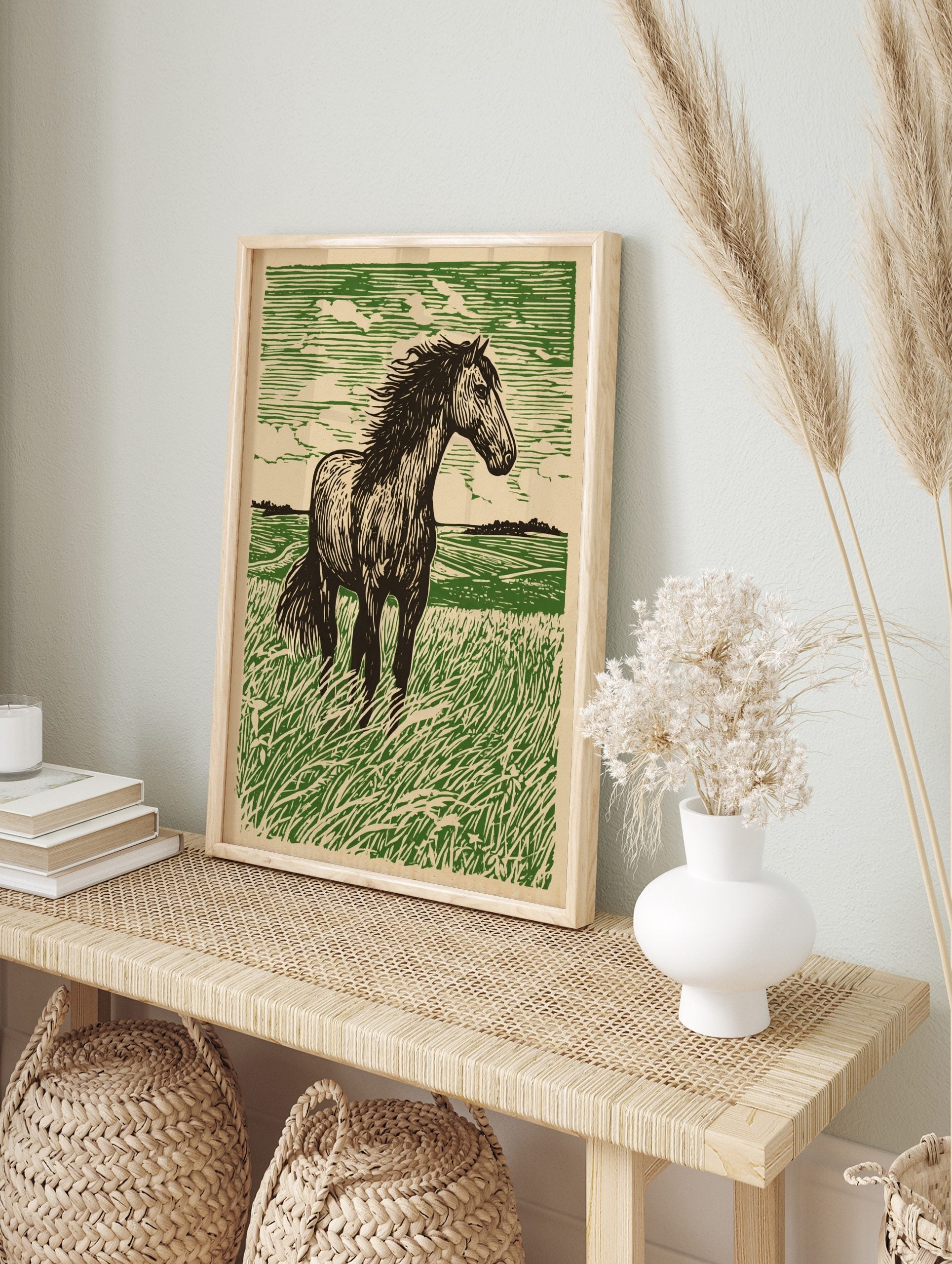 Linocut style art print of a dark green horse standing in a vibrant green field with a, in an alternate framed mockup