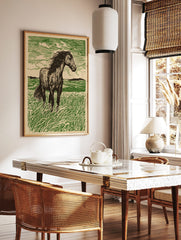 Linocut style art print of a dark green horse standing in a vibrant green field with a windswept, in a styled room mockup