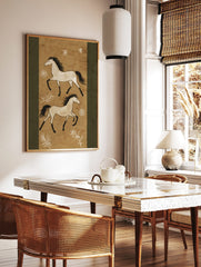 Two illustrative white horses with black manes and tails gallop on a textured tan background with, in a styled room mockup