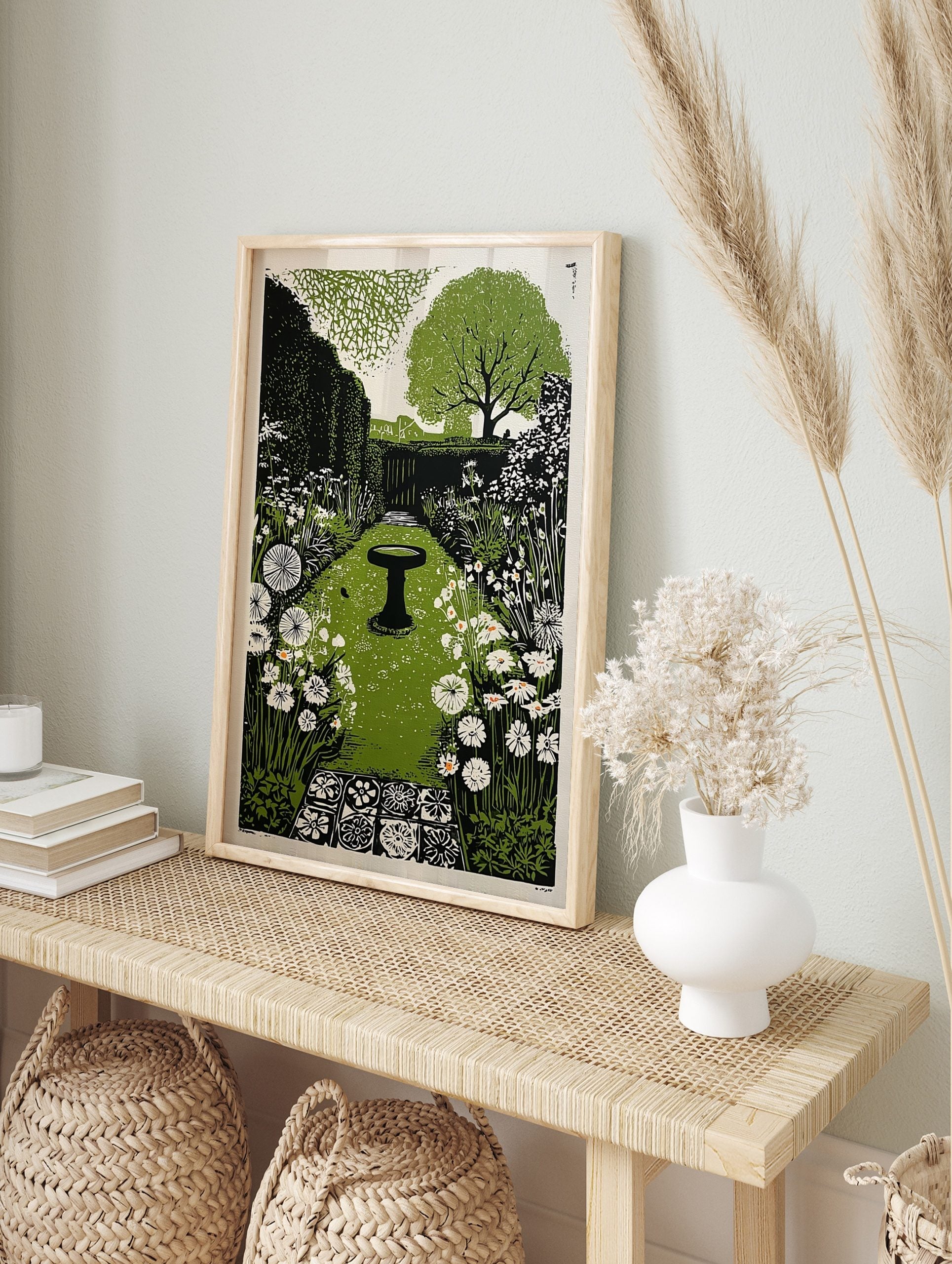 Illustrative garden print with central bird bath, green path, white flowers, and hedgerows, in an alternate framed mockup