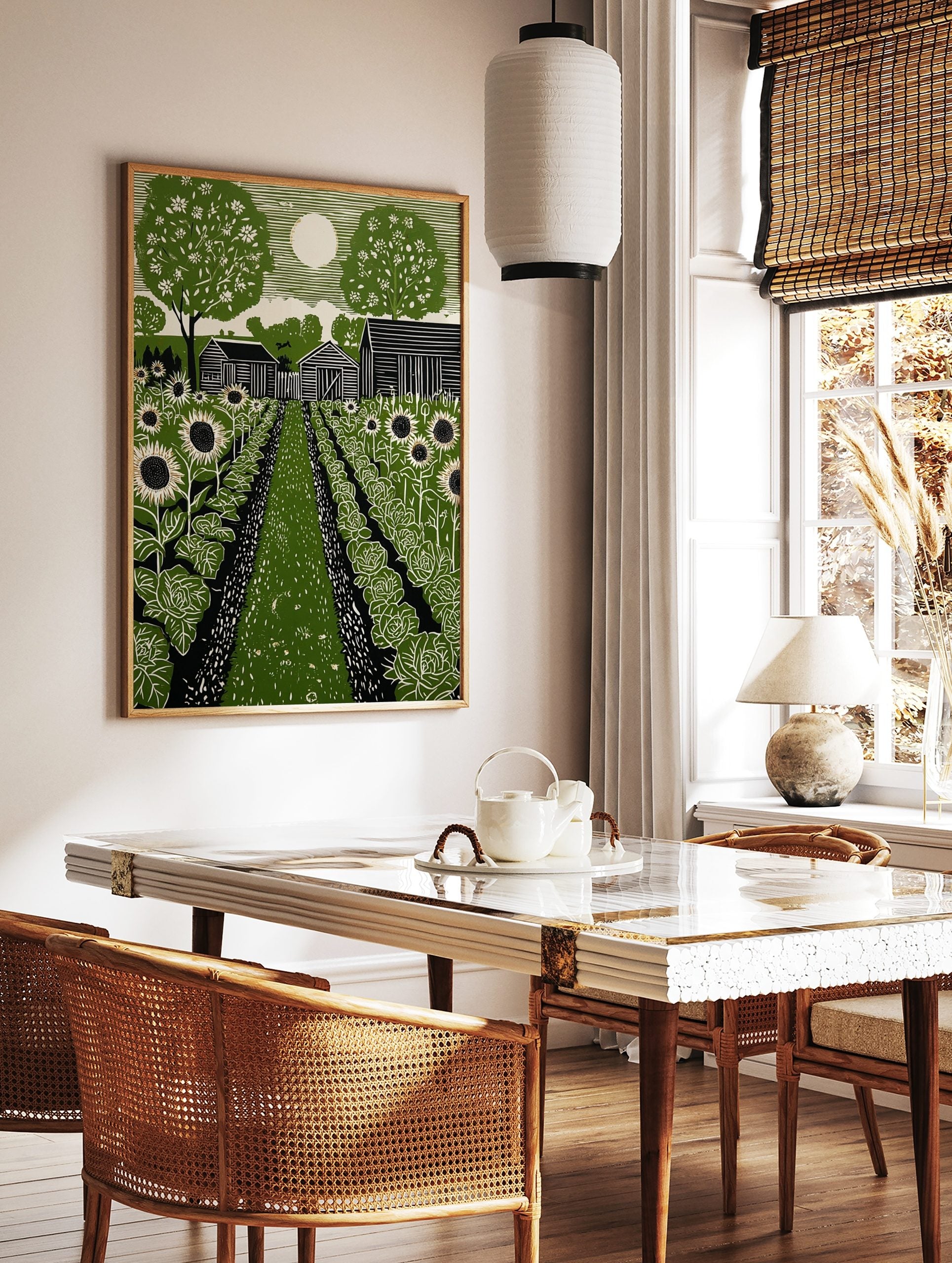 Green linocut print of a rural garden with sunflowers, cabbage, barns, trees, and a full moon in a, in a styled room mockup