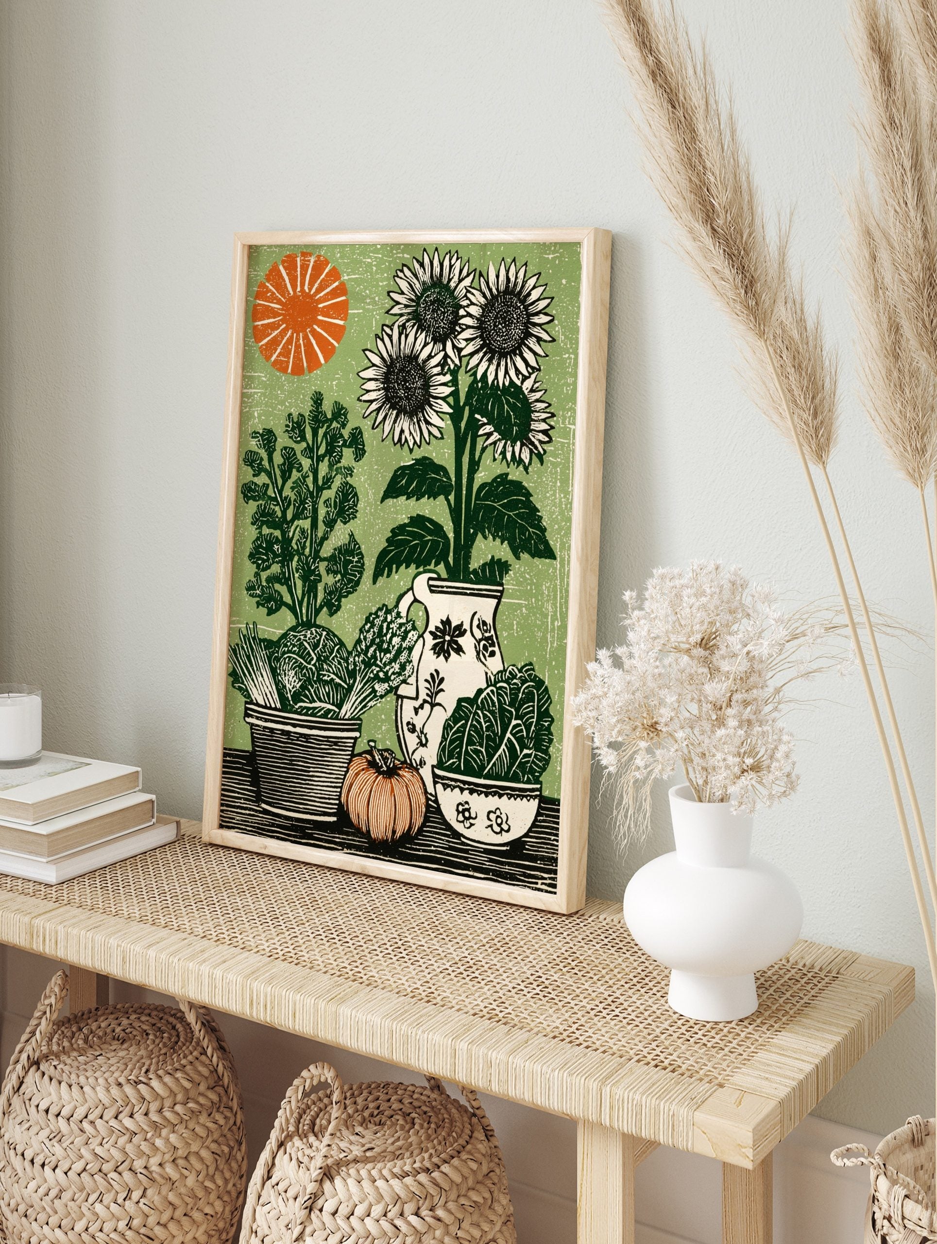 Linocut style botanical print of sunflowers, cabbage, asparagus, pumpkin, and sun on a green, in an alternate framed mockup