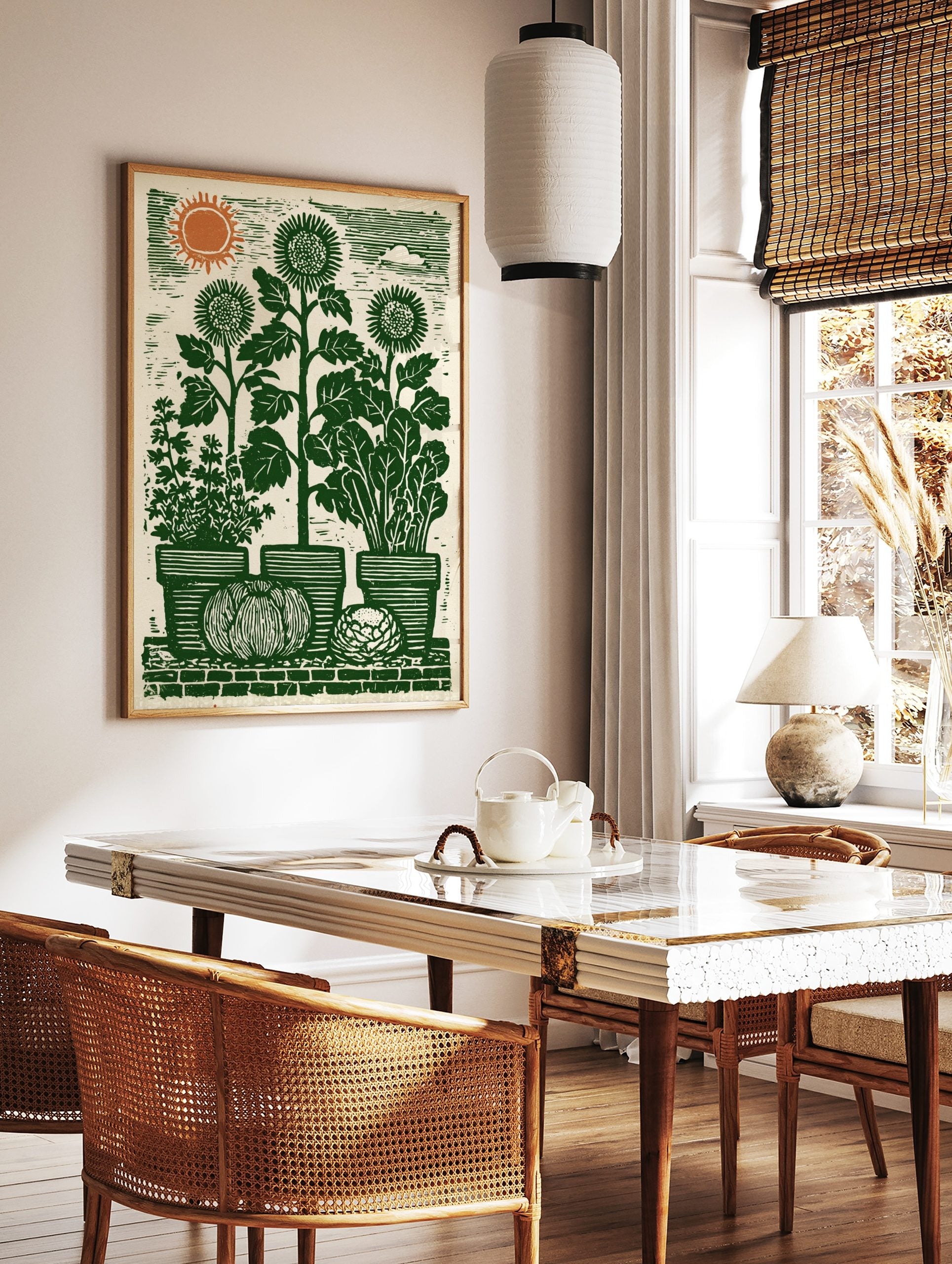 Green lino-cut style garden harvest print with sunflowers, potted herbs, pumpkin, and orange sun, in a styled room mockup