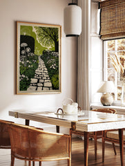 Illustrative garden path print with winding stone pathway, lush green foliage, and white flowers, in a styled room mockup