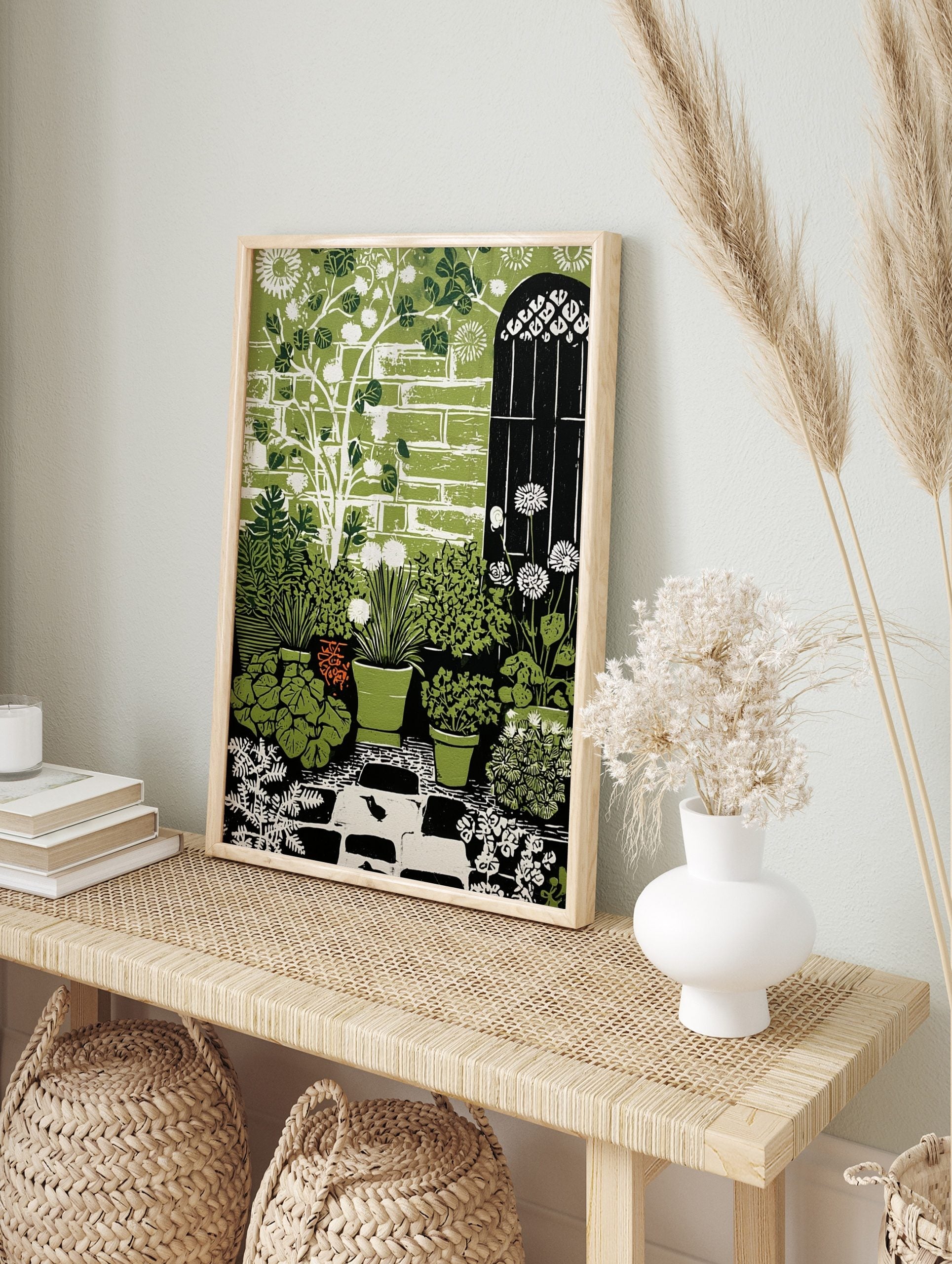 Illustrative green garden art print with potted plants, white dandelions, brick wall, arched, in an alternate framed mockup