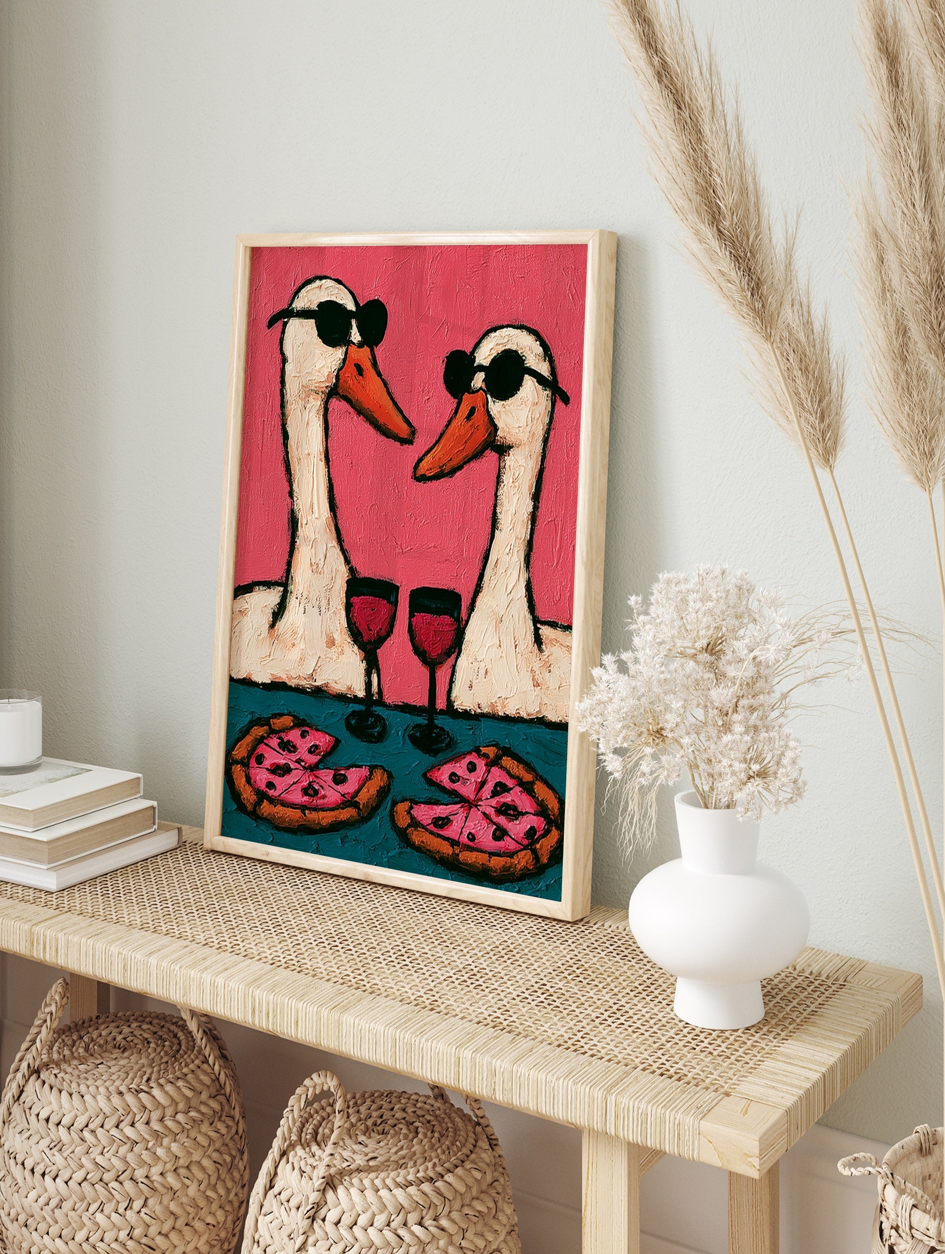 Playful wall art print of two geese wearing sunglasses, drinking wine, and eating pizza, in an alternate framed mockup