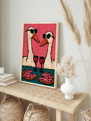 Playful wall art print of two geese wearing sunglasses, drinking wine, and eating pizza, in an alternate framed mockup