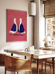 Two white geese in blue jackets with orange beaks on a textured pink background, facing each other, in a styled room mockup