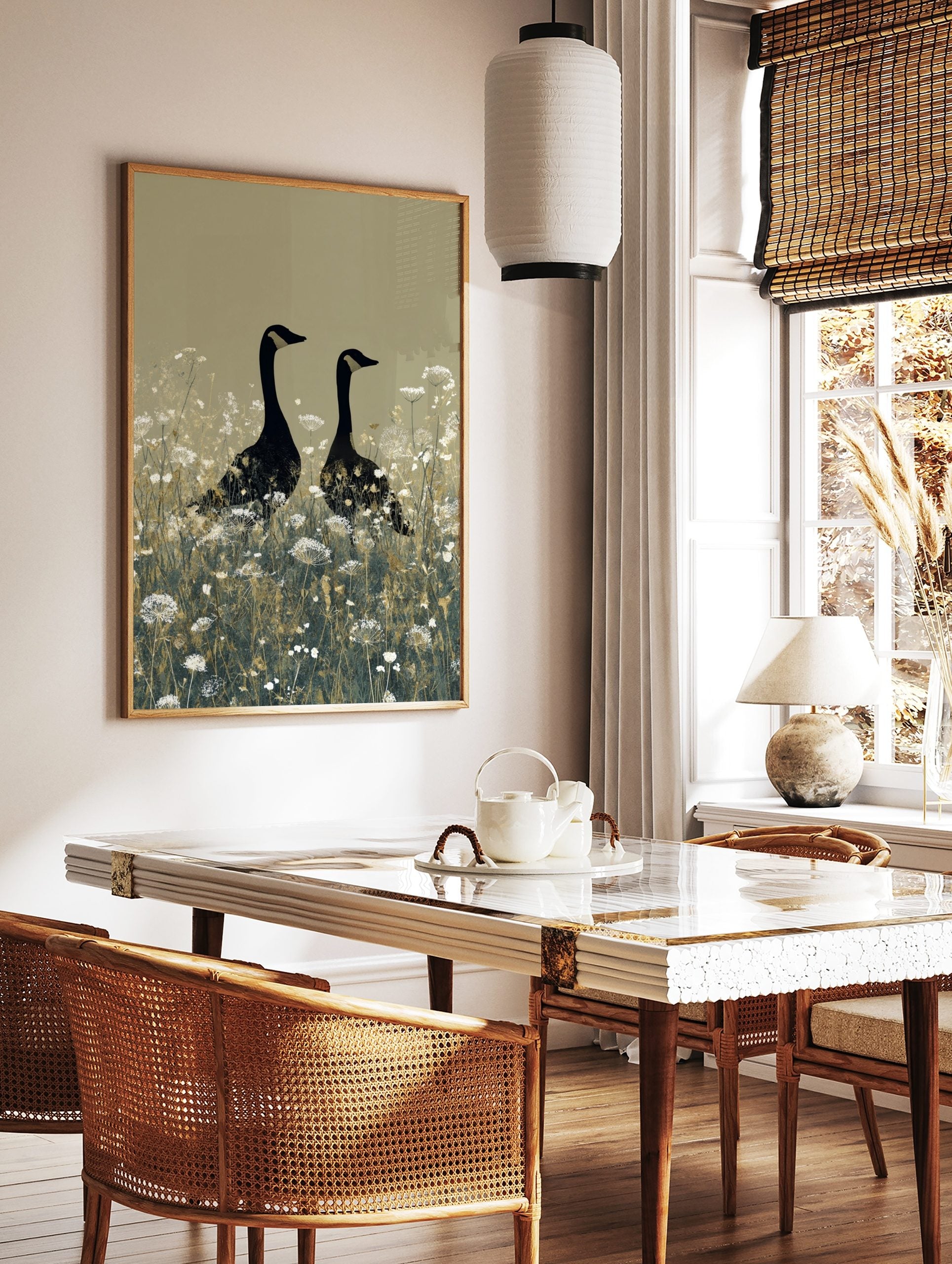 Two black geese with gold head markings standing in a field of white wildflowers on a beige, in a styled room mockup