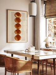 Minimalist geometric wall art with five stacked terracotta circles and vertical lines on a white, in a styled room mockup