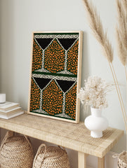 Geometric pattern wall art with orange speckled shapes on dark green, black triangles, and, in an alternate framed mockup