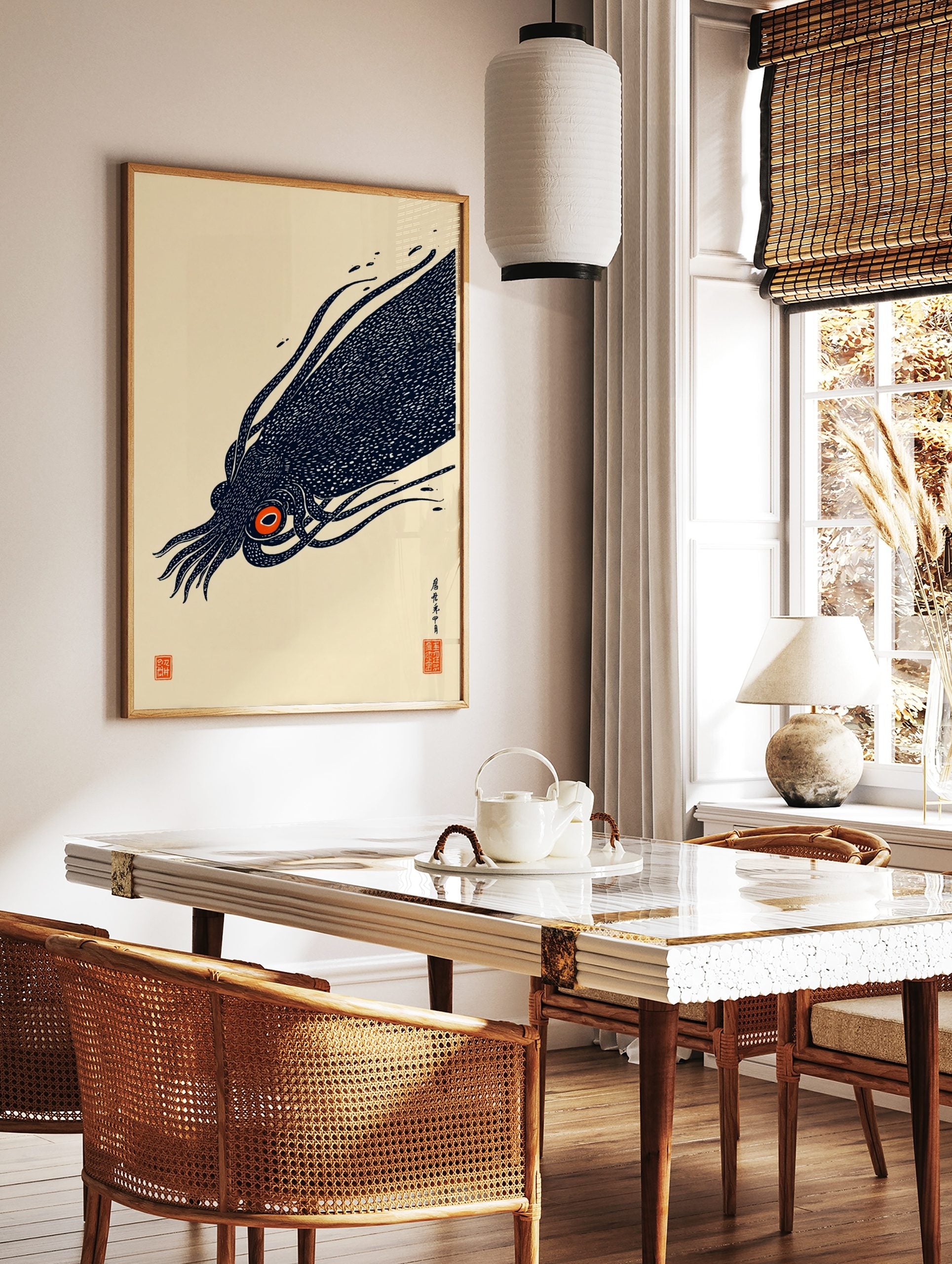 Illustrative print of a dark navy giant squid with a bright orange eye, featuring Japanese text and, in a styled room mockup