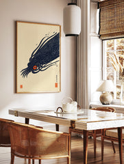 Illustrative print of a dark navy giant squid with a bright orange eye, featuring Japanese text and, in a styled room mockup