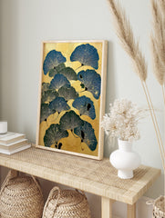 Illustrative ginkgo leaf botanical print in blue and green on a textured golden background, in an alternate framed mockup