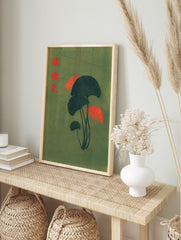 Botanical ginkgo leaves in dark green-blue and red on an olive-green background with red, in an alternate framed mockup