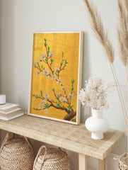 Gold cherry blossom wall art with white and pink flowers, green leaves, and brown branches on, in an alternate framed mockup