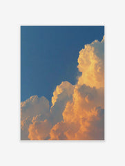 Dramatic golden cumulus clouds against a deep blue sky, capturing a vibrant sunset or sunrise
