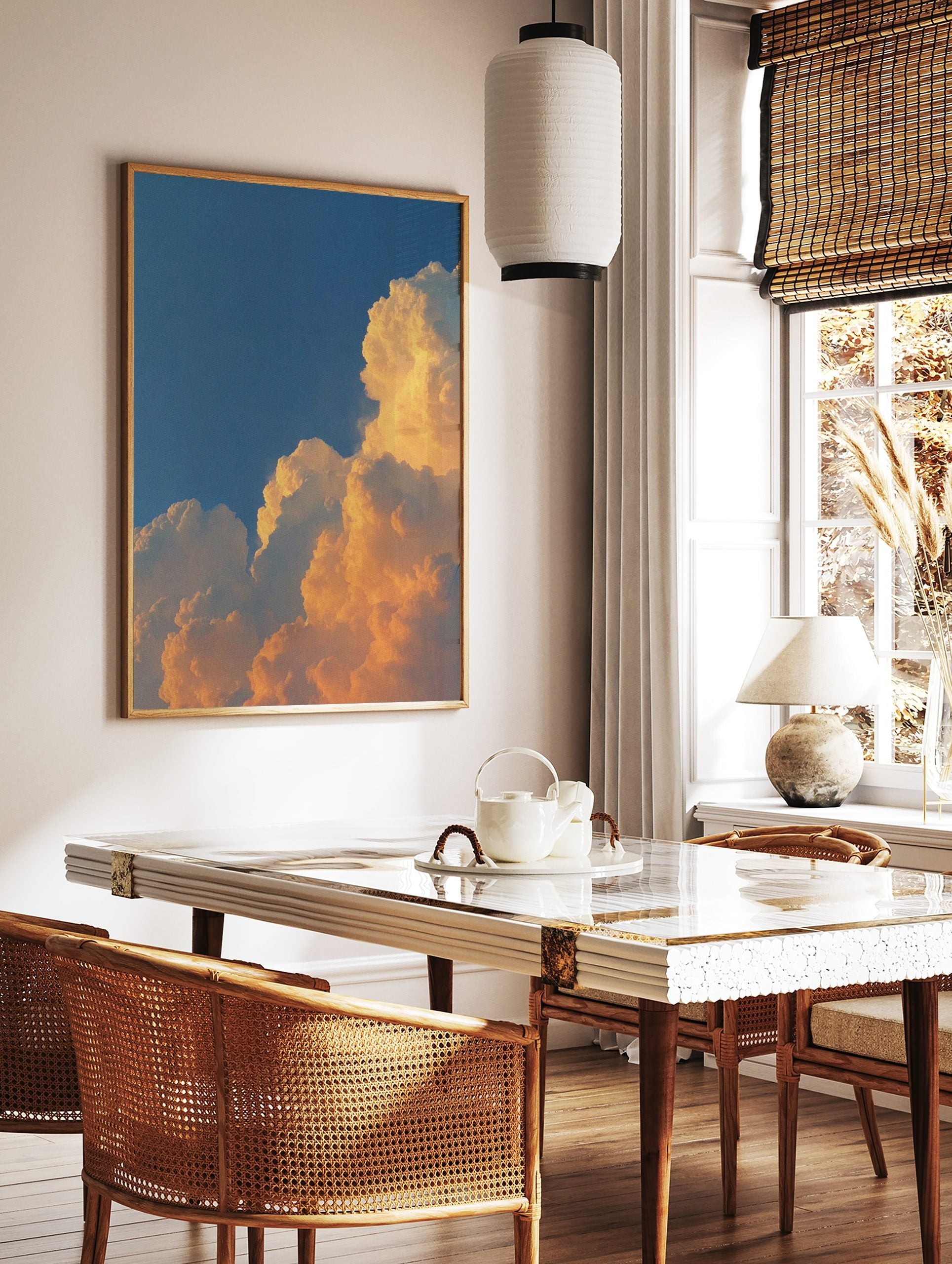 Dramatic golden cumulus clouds against a deep blue sky, capturing a vibrant sunset or sunrise, in a styled room mockup