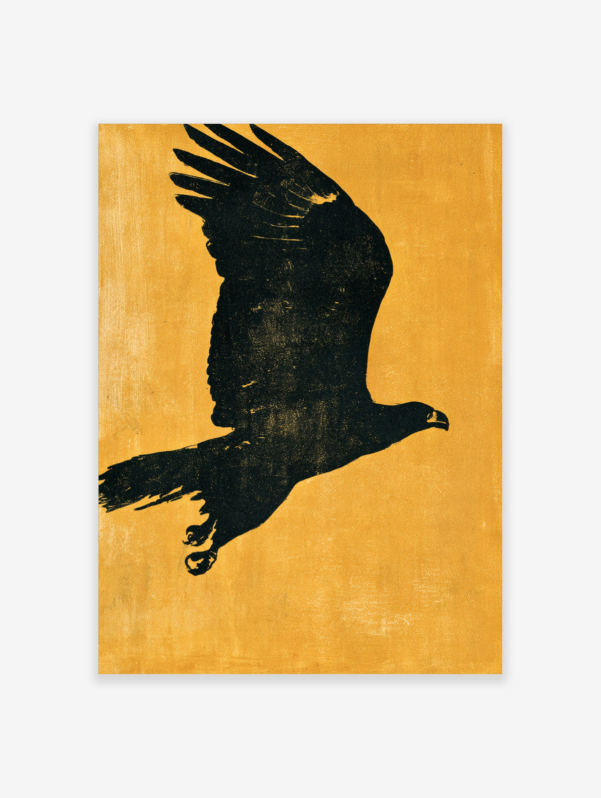 Black silhouette of a golden eagle in flight with raised wings and talons against a textured yellow background
