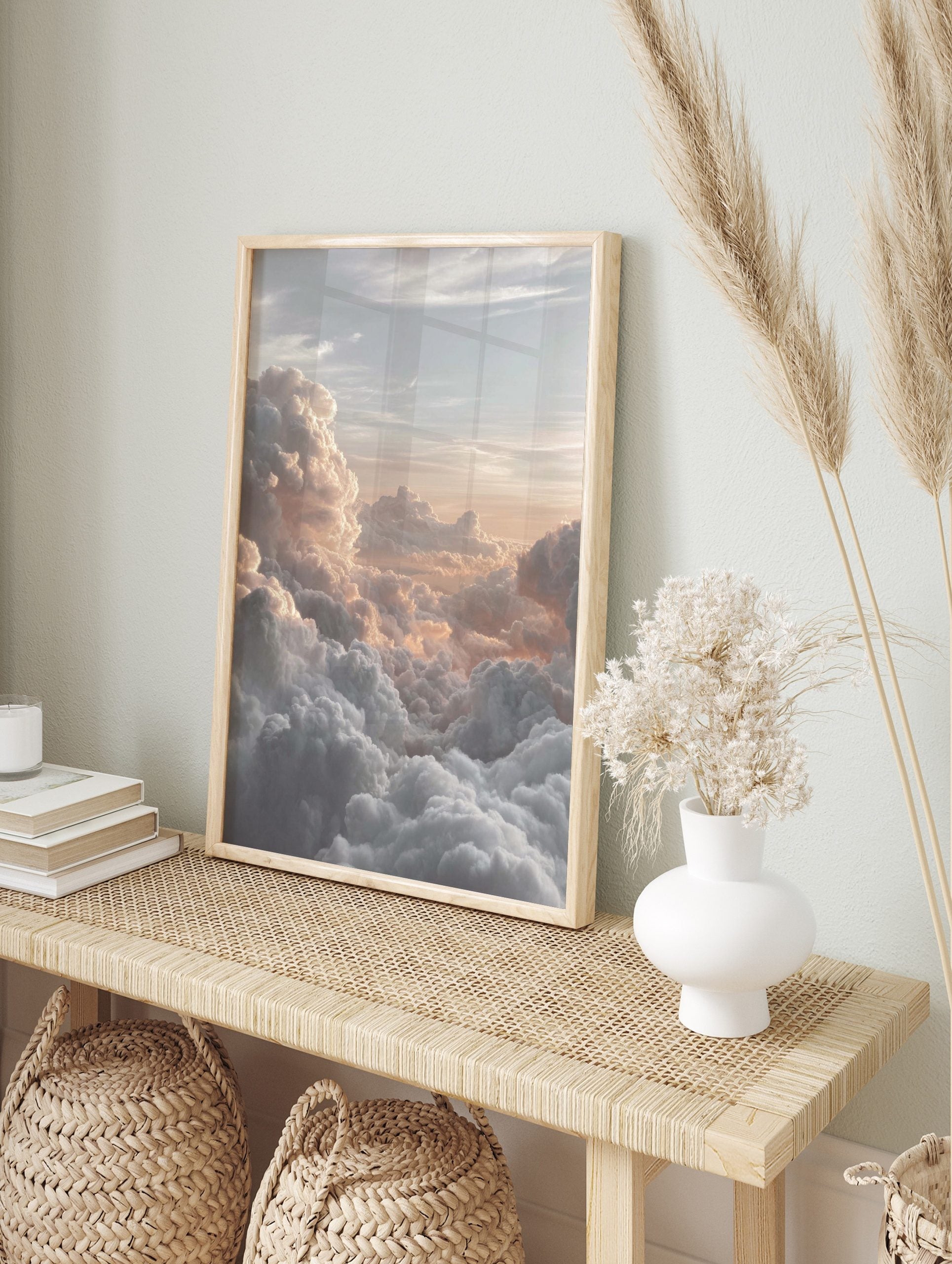 Photographic print of voluminous clouds bathed in warm golden and peach light at sunrise or, in an alternate framed mockup