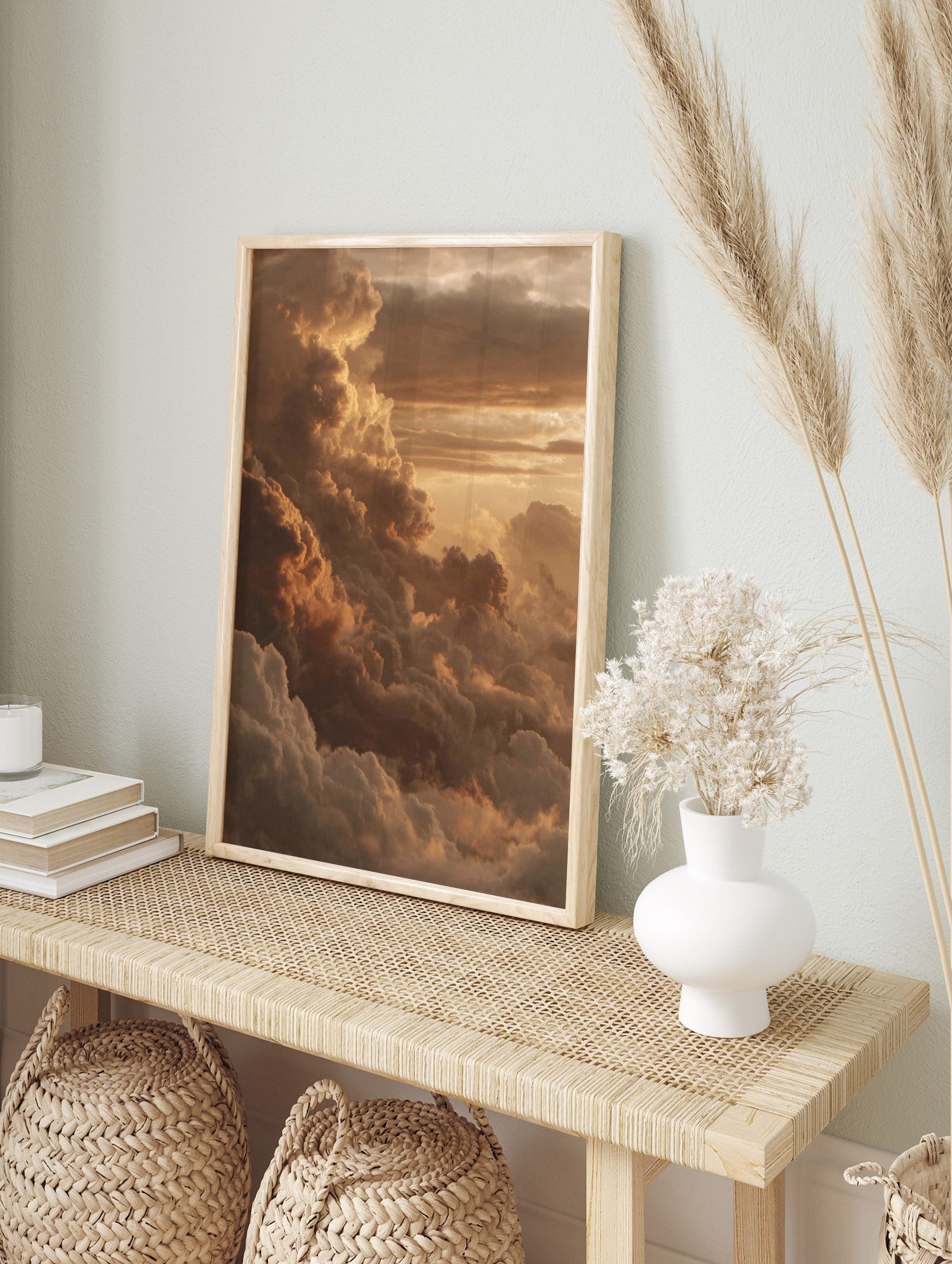 Dramatic golden sunset cloud formations in warm orange and brown hues, filling the sky, in an alternate framed mockup