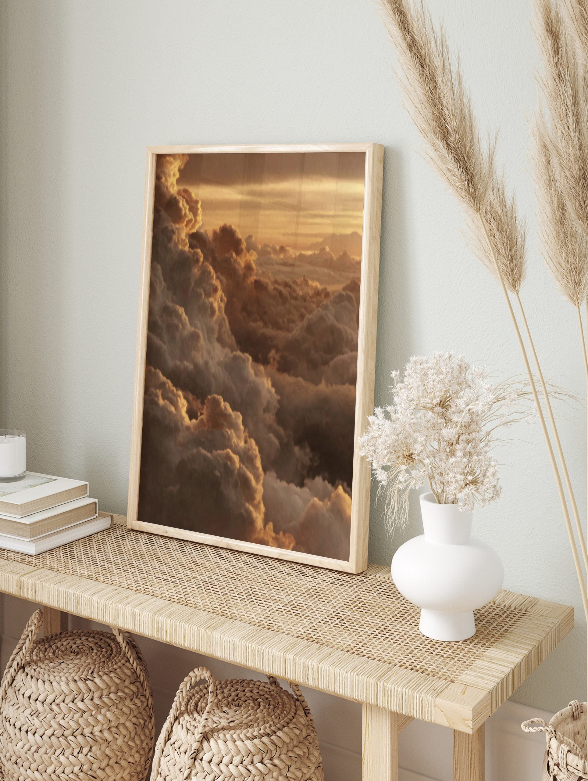 Golden cumulus clouds at sunset, with light catching the edges of the atmospheric sky print, in an alternate framed mockup