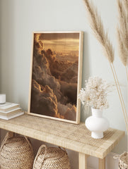 Golden cumulus clouds at sunset, with light catching the edges of the atmospheric sky print, in an alternate framed mockup
