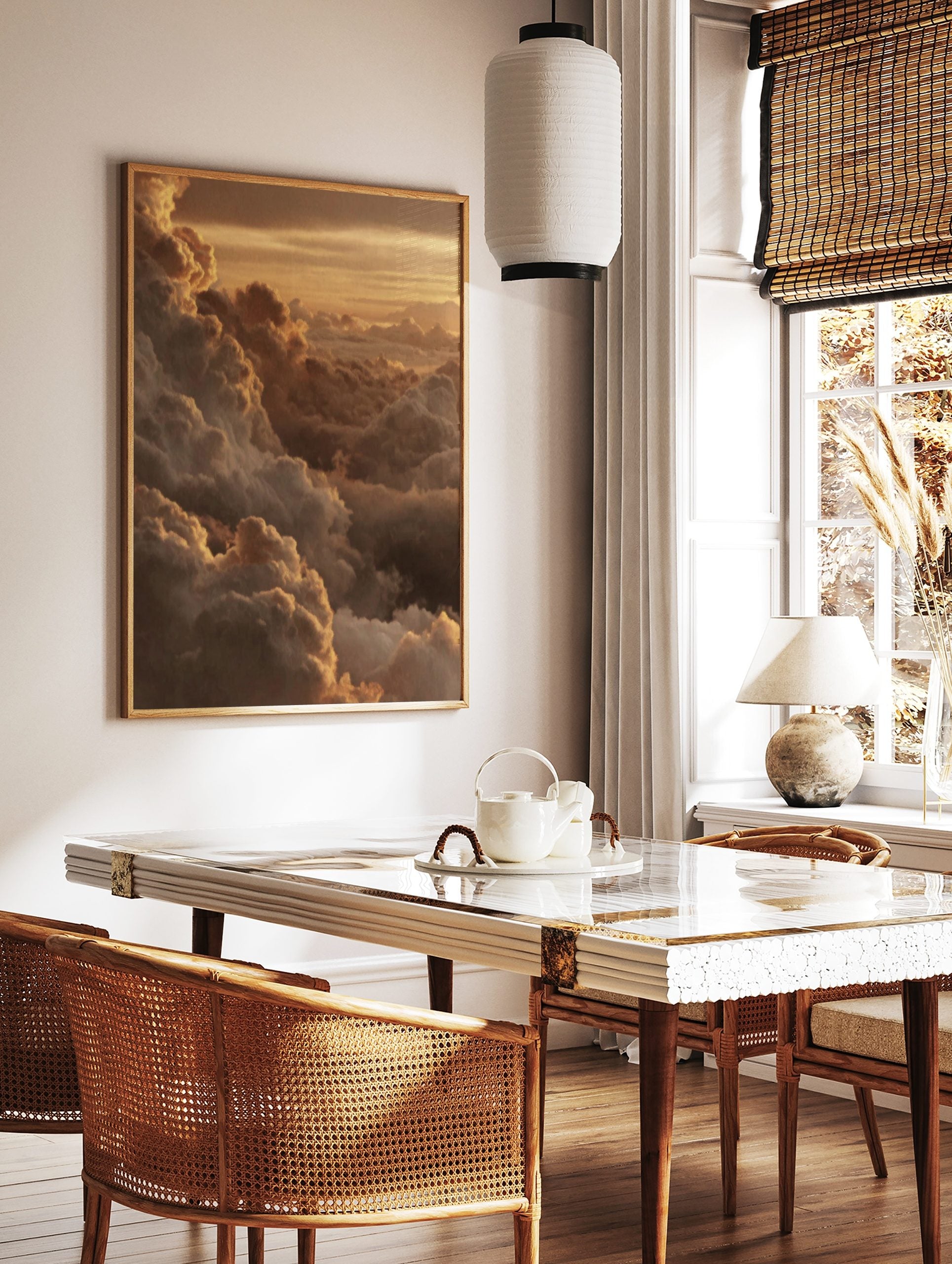 Golden cumulus clouds at sunset, with light catching the edges of the atmospheric sky print, in a styled room mockup