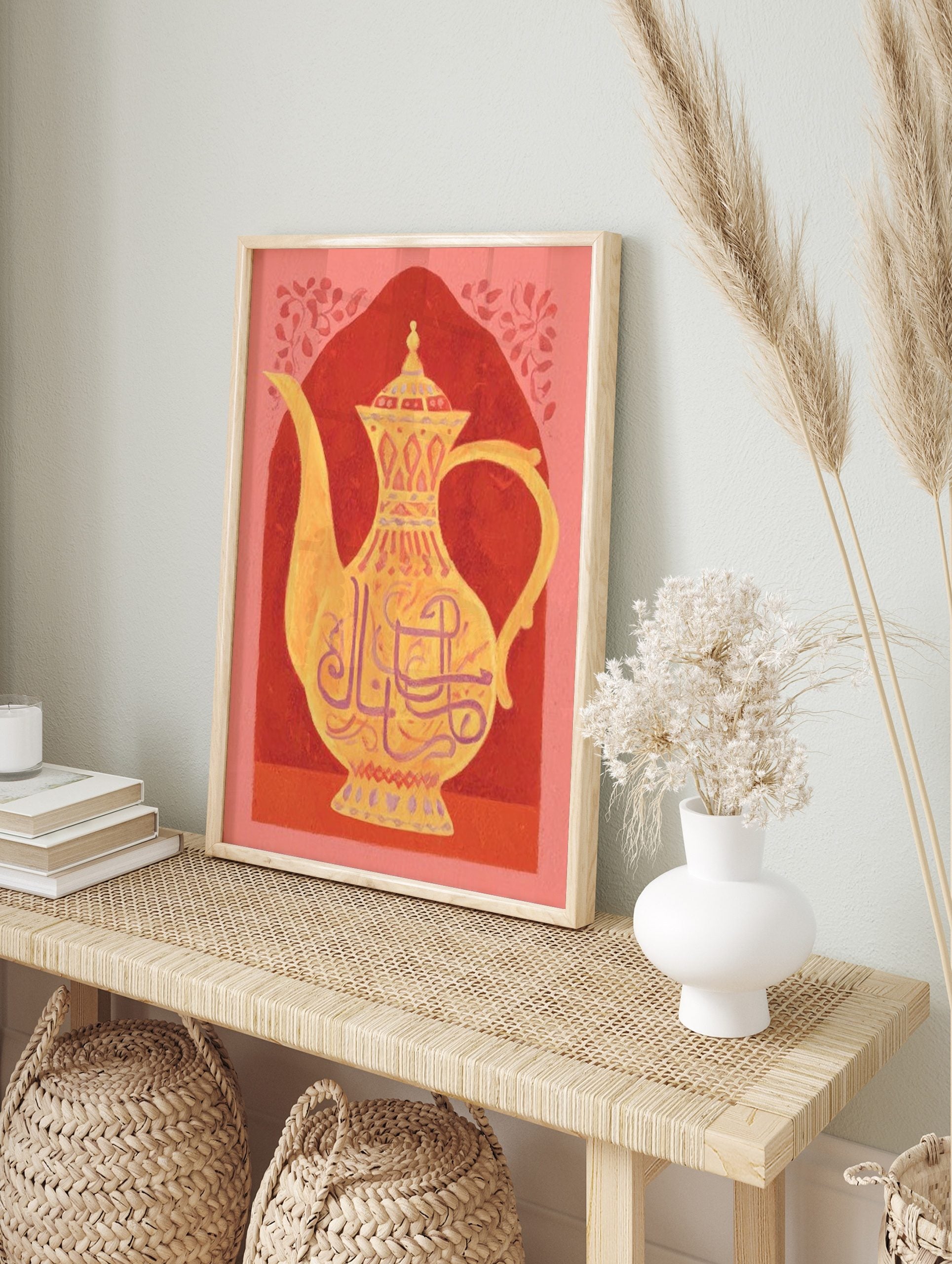 Ornate golden teapot with Arabic calligraphy and patterns against a red arched background, in an alternate framed mockup