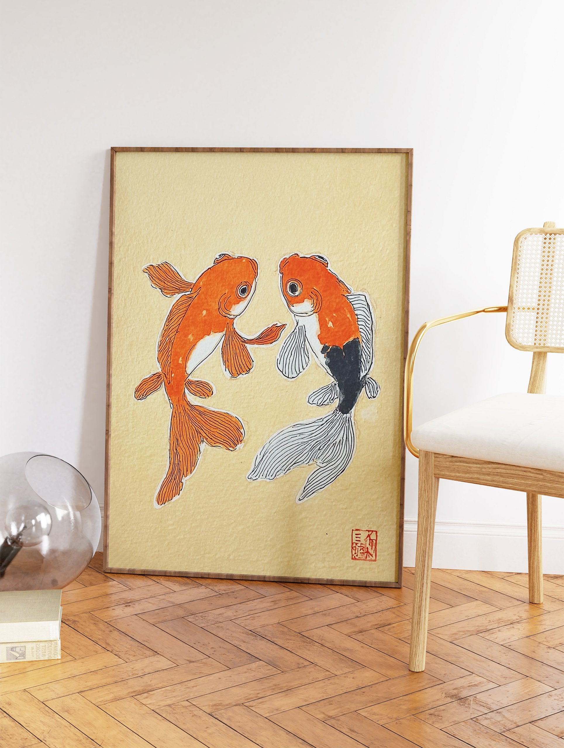 Japanese-style illustration of two orange and black goldfish on a light yellow textured background with a red seal. - Image 2