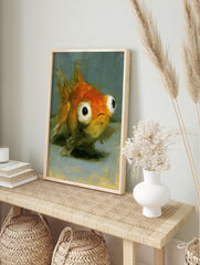 Close-up painterly illustration of a goldfish with large, expressive eyes on a grey background, in an alternate framed mockup