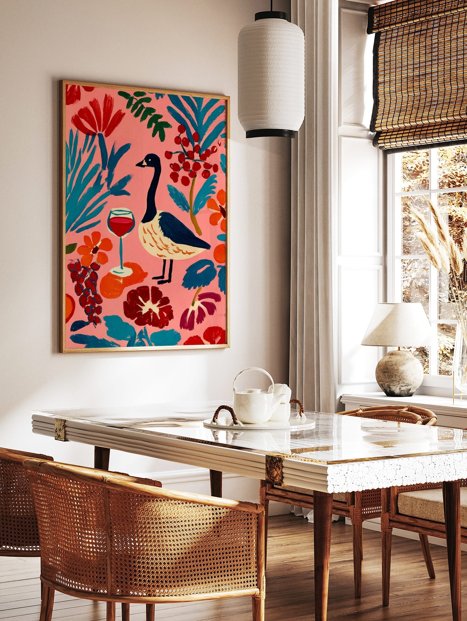 Colourful illustrative wall art of a goose, red wine glass, and abstract botanical elements on a, in a styled room mockup