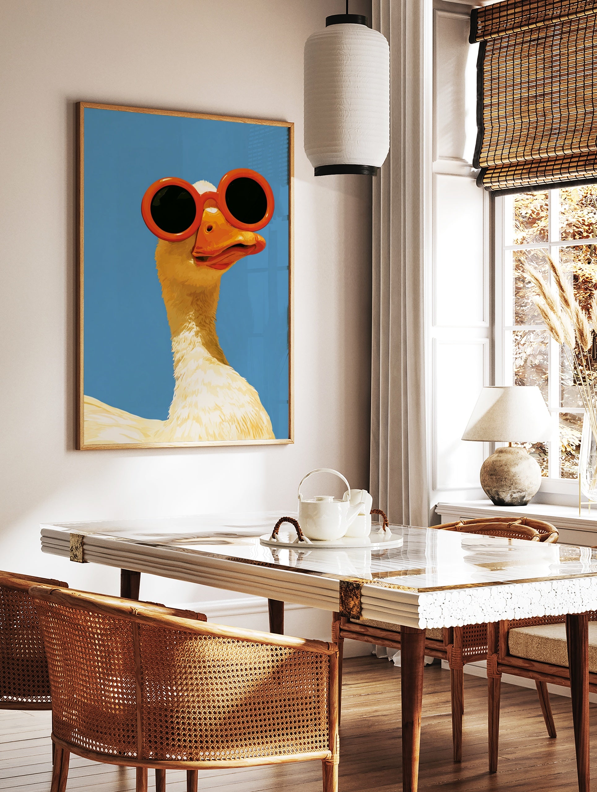 Illustration of a white goose wearing large, round orange sunglasses against a solid, bright blue, in a styled room mockup