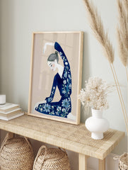 Illustrative art print of a woman in a navy floral outfit with arm raised, on a beige, in an alternate framed mockup
