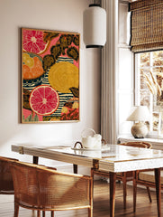 Illustrative art print of sliced red grapefruit, orange citrus, patterned leaves, and stripes on a, in a styled room mockup