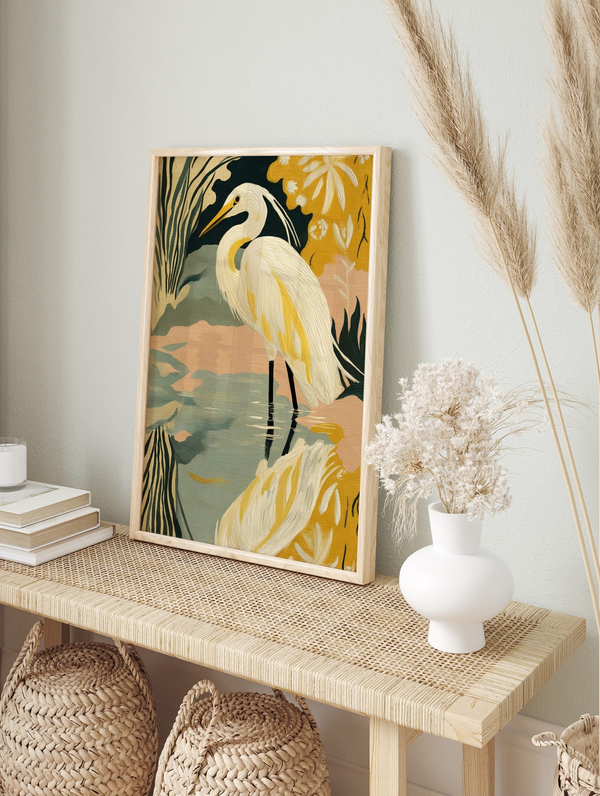 Illustrative print of a white great egret in water with green and yellow stylised foliage, in an alternate framed mockup