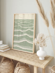 Abstract wave pattern wall art with layered sage green and cream lines on satin paper, in an alternate framed mockup