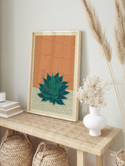 Green agave plant botanical illustration art print on orange-brown textured background with, in an alternate framed mockup