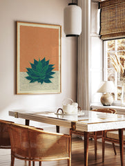 Green agave plant botanical illustration art print on orange-brown textured background with cracked, in a styled room mockup