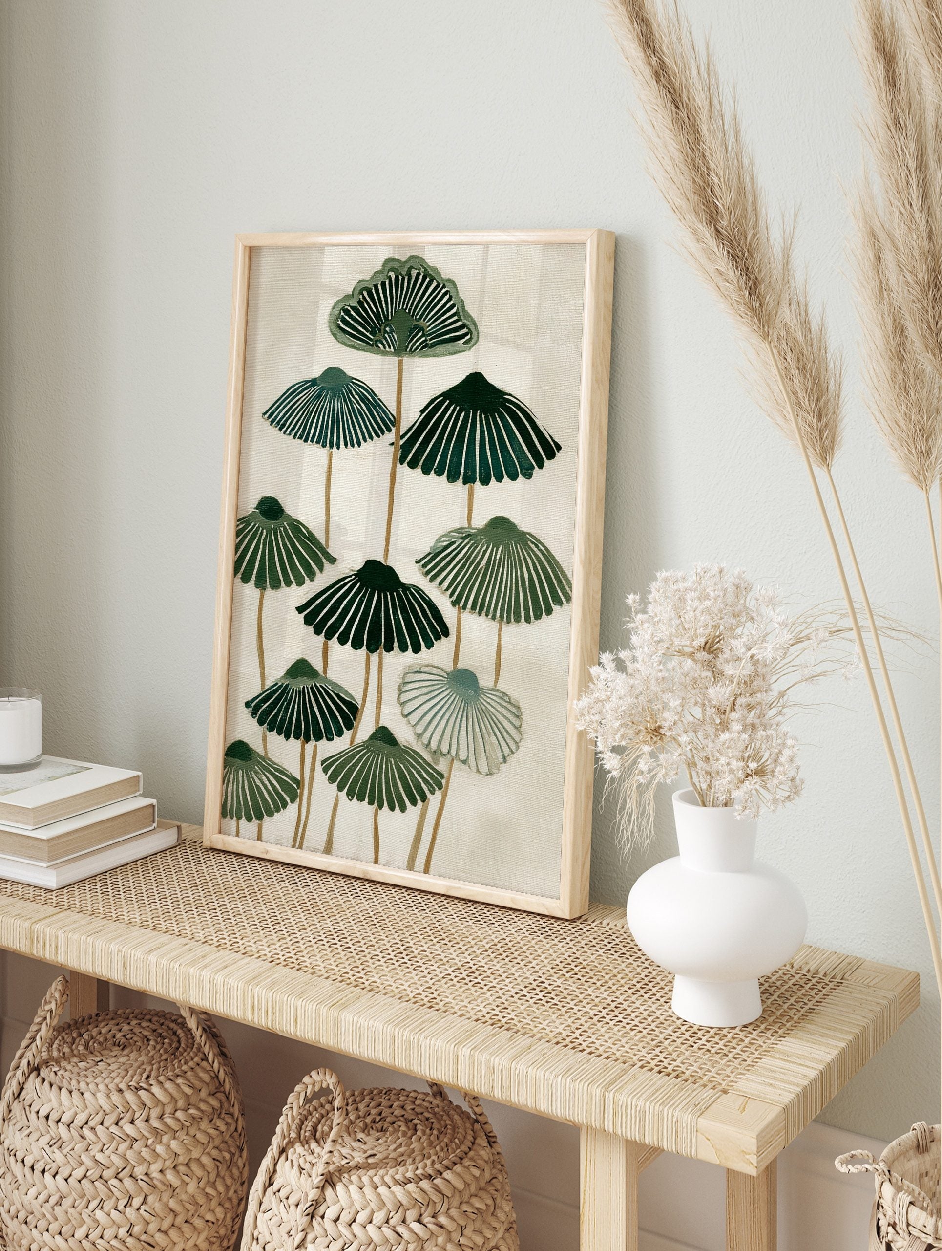 Stylised green botanical fan shapes with radiating lines on a cream background, abstract, in an alternate framed mockup