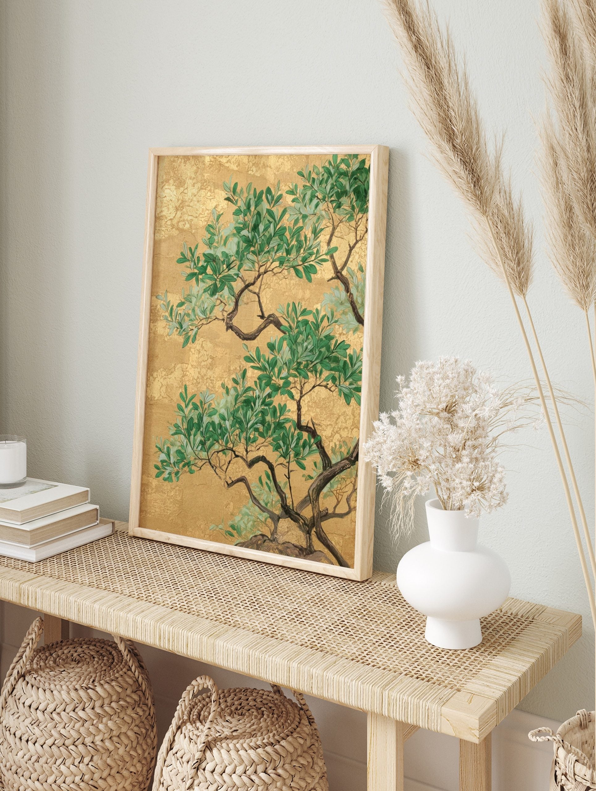 Green botanical tree branches with leaves against a textured gold background in an, in an alternate framed mockup