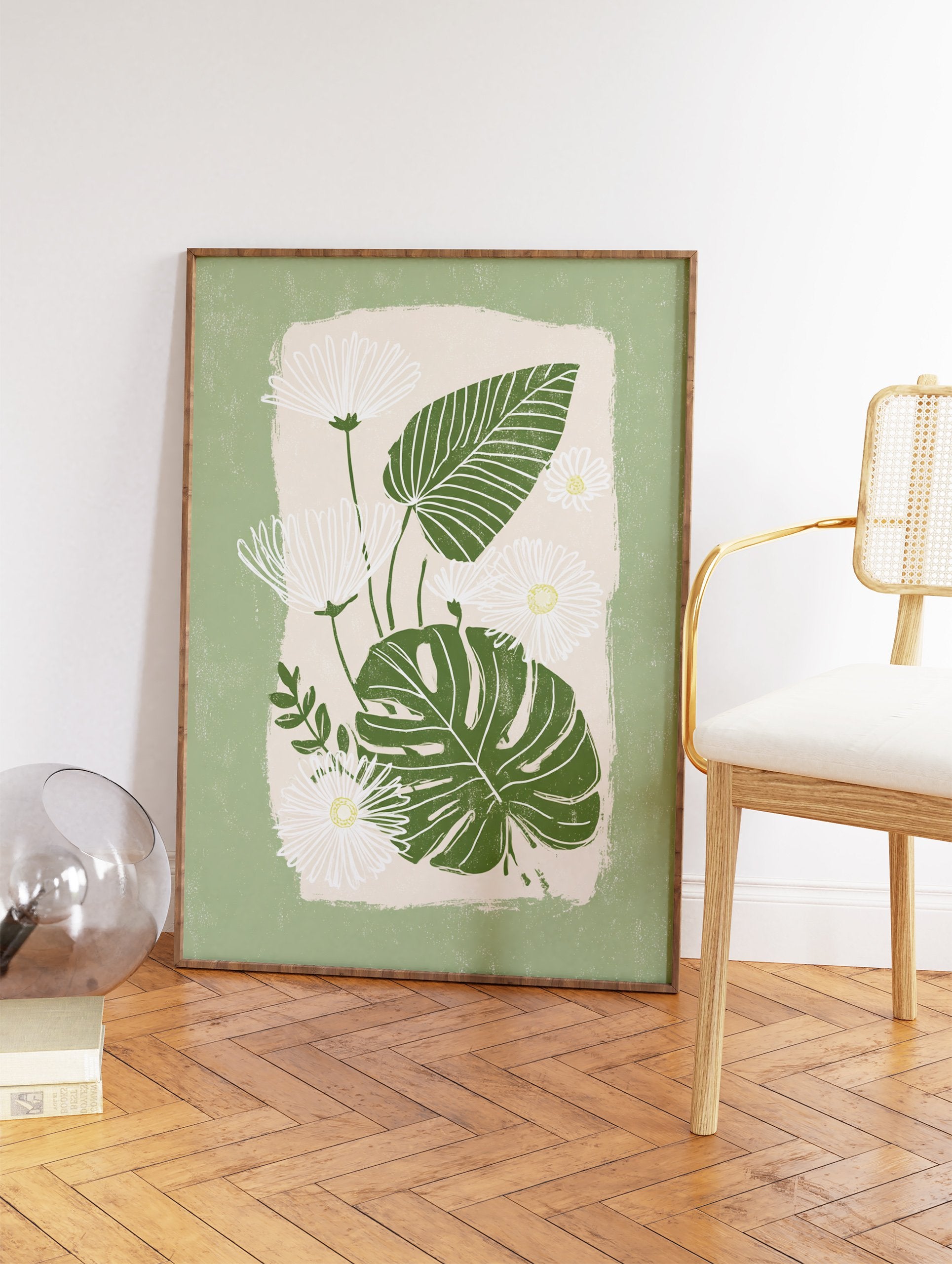 Green botanical wall art featuring white daisies with yellow centers and dark green monstera leaves on a light beige background. - Image 2