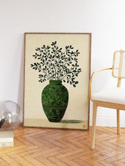 Green botanical wall art print of a vase with leafy branches on a textured light background, with a subtle shadow. - Image 2