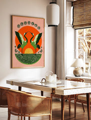Illustrative print of two green cranes with spread wings against an orange sun and green water, in a styled room mockup