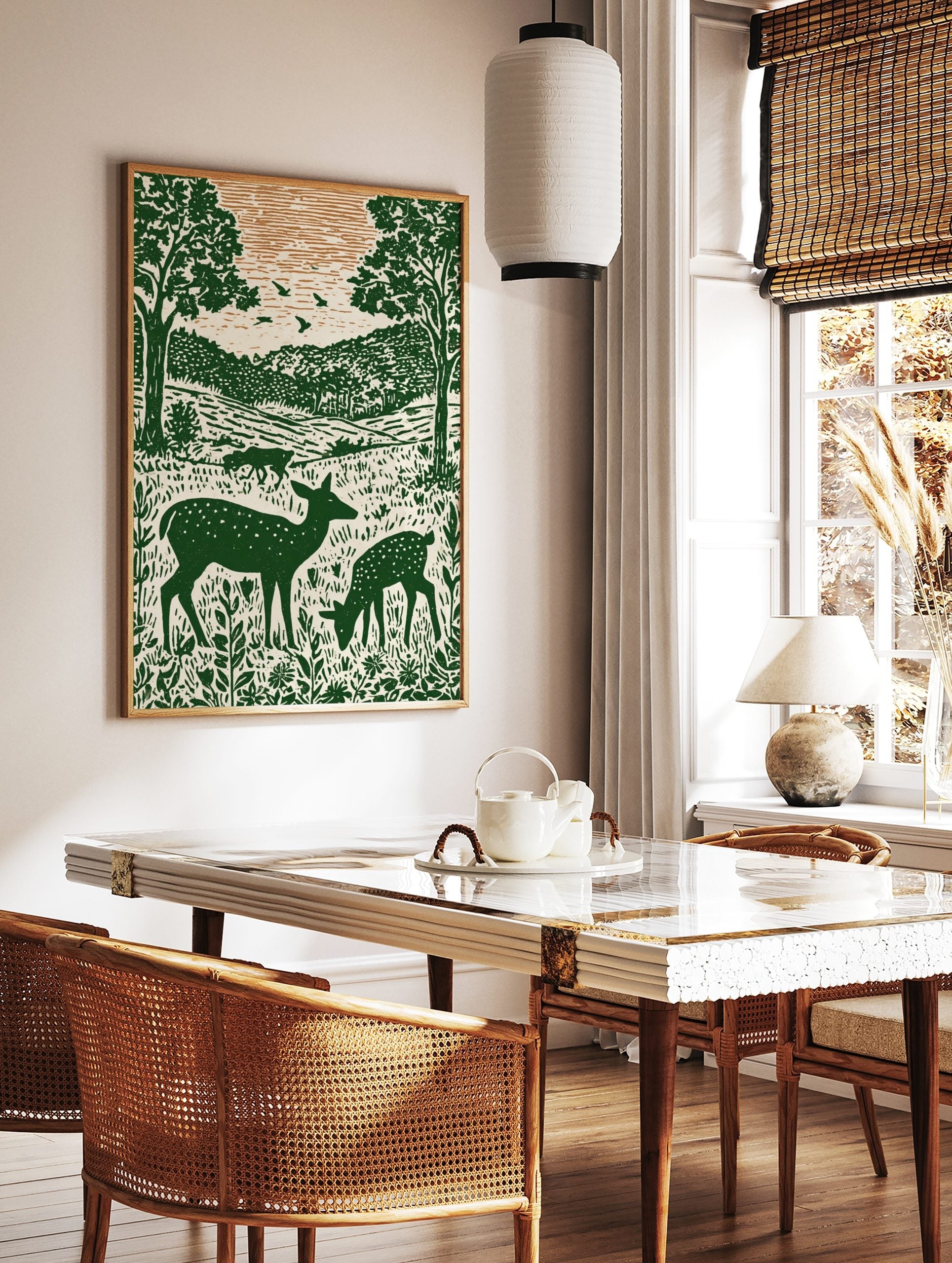 Illustrative green deer family in forest with trees and hills, woodcut style nature print, in a styled room mockup